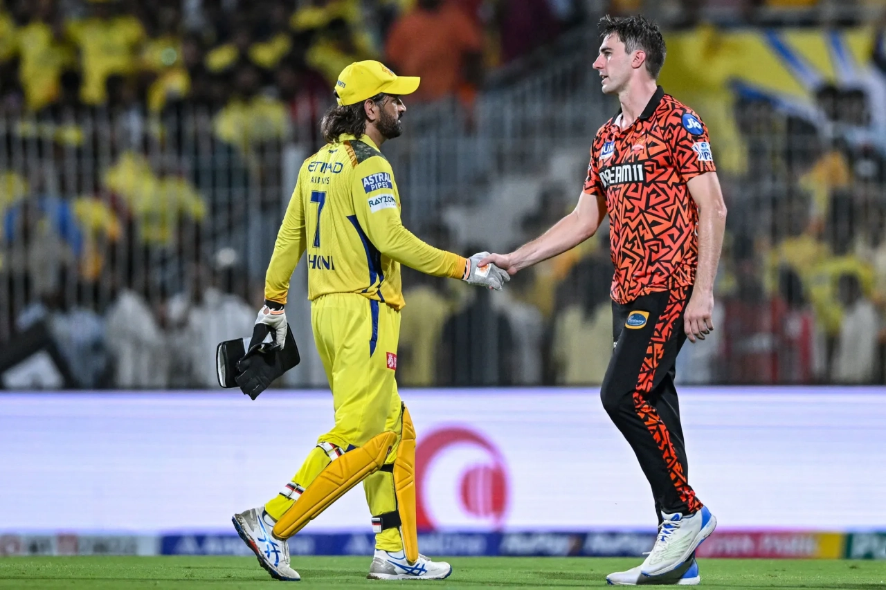 Cummins (right) shakes the hand of star CSK keeper MS Dhoni // Getty